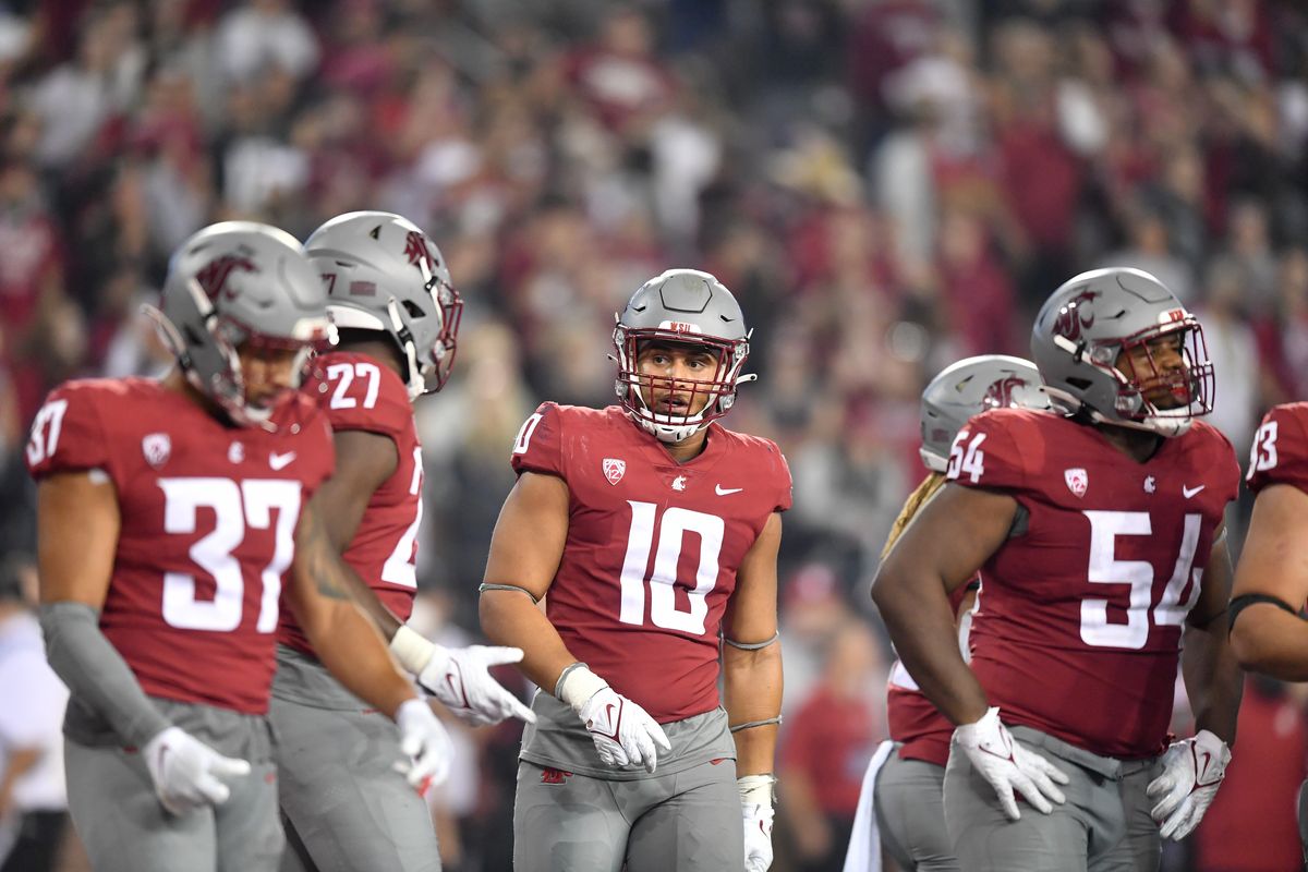 Washington State Cougars defensive end Ron Stone Jr. (10) reacts with his teammates after the Utah State Aggies scored a touchdown to defeat WSU in the final seconds of the second half Saturday, Sep 4, 2021, at Gesa Field in Pullman, Wash.  (Tyler Tjomsland/The Spokesman-Review)