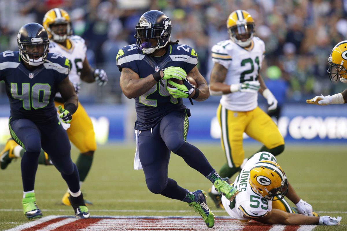 Seattle’s Marshawn Lynch avoids tackle from Green Bay’s Brad Jones to pick up some of the 110 yards he gained on 20 carries. Lynch scored twice in 36-16 win. (Associated Press)