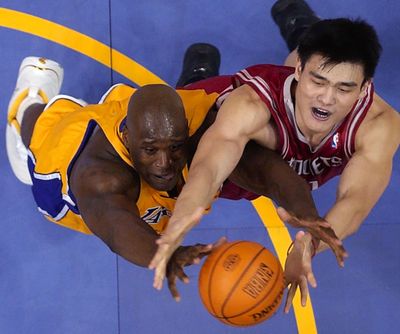 In this April 17, 2004, file photo, Los Angeles Lakers' Shaquille O'Neal, left, goes after a rebound along with Houston Rockets' Yao Ming during the first half of the first round of the Western Conference playoffs, in Los Angeles. This year's Hall of Fame class includes a star-studded field of potential finalists, including Shaquille O'Neal, Yao Ming and Allen Iverson. That trio should be a lock to get in. (MARK J. TERRILL / Associated Press)