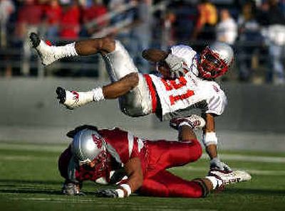 
WSU lineback Scott Davis hits and flips New Mexico reciever Adrian Boyd after a short gain in the fourth quarter of last year's matchup.
 (File/ / The Spokesman-Review)