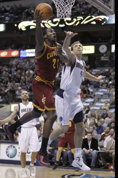 Cleveland Cavaliers forward J.J. Hickson (left) drives to the basket against Dallas Mavericks forward Dirk Nowitzki. (Associated Press)