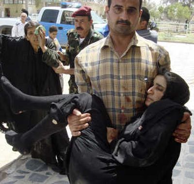 Women injured in a car bomb attack are brought to a hospital in Baqouba on Tuesday. According to police and hospital officials, at least 40 people were killed and 70 wounded in the blast. Associated Press
(Associated Press / The Spokesman-Review)