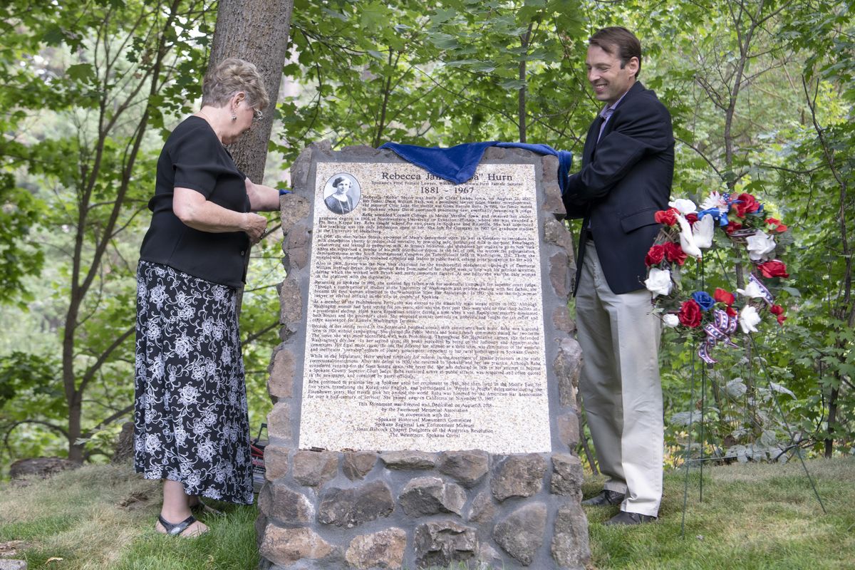 Sue Walker and Washington state Sen. Andy Billig unveil a memorial to Rebecca Reba Hurn, Spokane’s first female lawyer and state senator, who died in 1967. Hurns life and work was commemorated with her life story on a detailed stone near her grave at Greenwood Memorial Terrace on Friday, Aug. 3, 2018. The stone joins a couple of dozen other story stones placed near the graves of notable people at cemeteries around the area by the Fairmount Memorial Society with assistance from volunteer groups and donors. (Jesse Tinsley / The Spokesman-Review)
