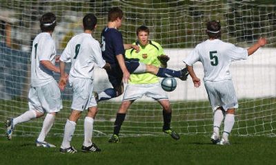 
It's a scramble in front of the net as Lucas Chesher shoots in front of East Valley goalkeeper Josh Peck to close within a goal, but the Knights held on to win. 
 (Kathryn Stevens / The Spokesman-Review)