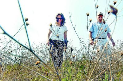 
Kootenai County weed supervisor Nina Eckberg and Kent Helmer, interim plant manager for the Hayden Regional Area Sewer Plant, walk the grounds  near the plant site on Monday  to come up with a plan to battle noxious weeds. 
 (Kathy Plonka / The Spokesman-Review)