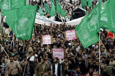 
Palestinian students, supporters of Hamas, chant anti-Israel slogans and wave Islamic flags during a rally Sunday to support the Hamas government at the Islamic University in Gaza City. 
 (Associated Press / The Spokesman-Review)