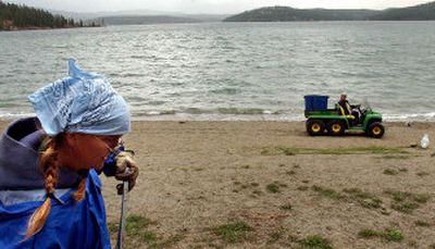 
Coeur d'Alene Parks Department worker Heather Hall cleans the beach at City Park on Monday. Public space on the waterfront is a city asset, said growth expert Maureen McAvey. 
 (Kathy Plonka / The Spokesman-Review)