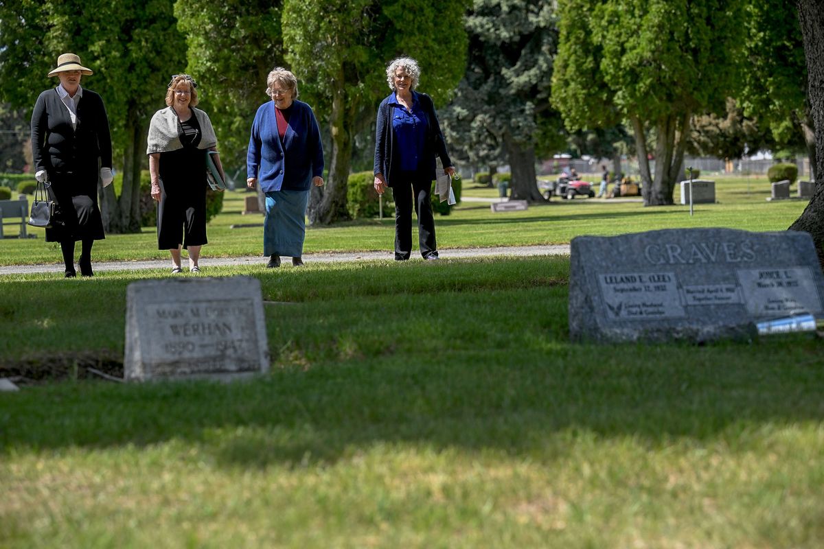 Members of the Eastern Washington Genealogical Society, from left, Kelly Martin, Melode Hall, Jeanne Coe and Lynn Krogh, walk through Pines Cemetery in Spokane Valley on May 20. The group chose a few tombstones there to research and will give presentations at the cemetery on Memorial Day.  (Kathy Plonka/The Spokesman-Review)