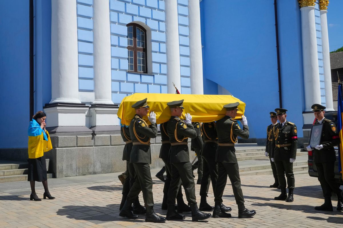Soldiers carry a coffin with remains of volunteer soldier Oleksandr Makhov, a well-known Ukrainian journalist, killed by the Russian troops, on Monday at St Michael cathedral in Kyiv, Ukraine.  (Efrem Lukatsky)