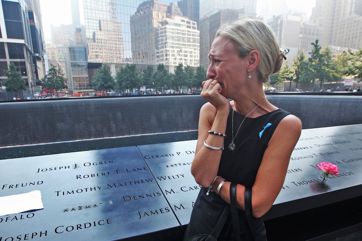 New York City Carrie Bergonia, of Pennsylvania, looks over the name of her fiancé, firefighter Joseph Ogren, at the 9/11 Memorial during ceremonies marking the attacks on the World Trade Center.