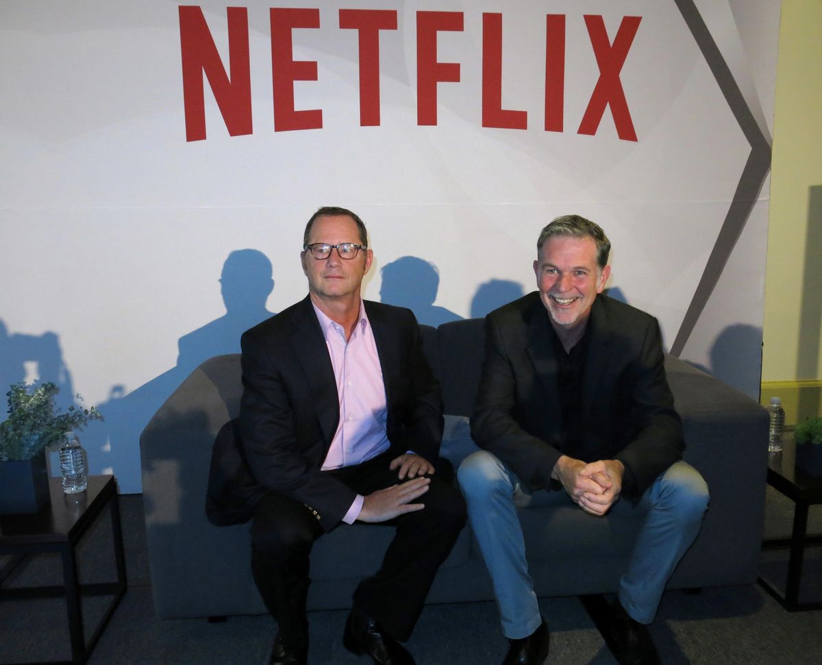 Reed Hastings, CEO and founder of Netflix, right, sits with Jonathan Friedland, global director of communications, Nov. 24, 2014, as they pose for a portrait during a press conference about their three years of doing business in Latin America, in Mexico City. Hastings said he fired the company’s top spokesman over use of a derogatory racial term. The spokesman, Friedland, confirmed in tweets Friday, June 22, 2018, that he was leaving the company, saying he was insensitive in speaking with his team about words that offend in comedy. (Berenice Bautista / Associated Press)