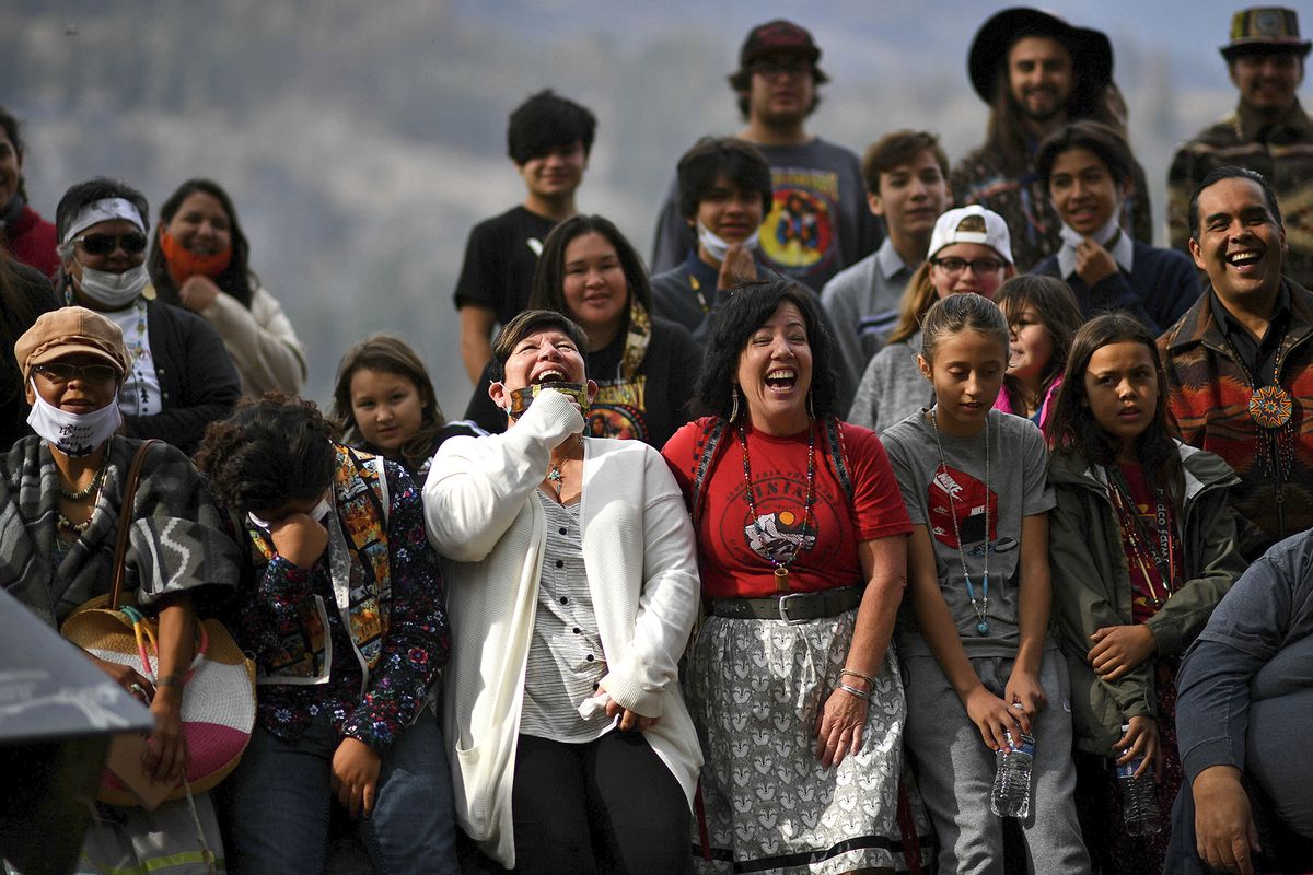 Linda Desautel, center in white, looks skyward and cheers with friends and Colville Confederated Tribe members as they rally in support of her husband Rick Desautel, whose case in the Canadian Supreme court arguing for the Sinixt peoples