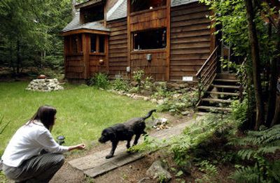
Tal Harlan calls her dog Endo in front of her home off of Pack River Road, north of Sandpoint. She and her husband bought outside of town due to rising real estate prices in Sandpoint. 
 (Kathy Plonka / The Spokesman-Review)