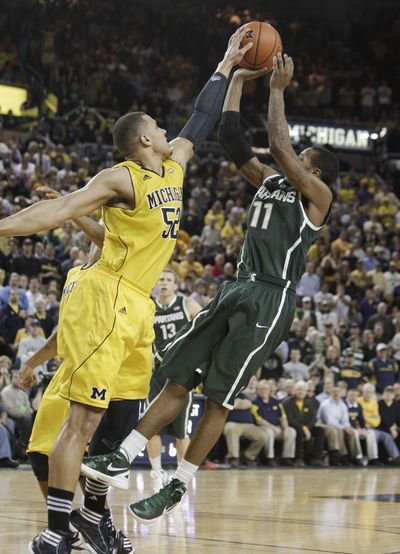 Jordan Morgan blocks a shot by Michigan State’s Keith Appling. (Associated Press)