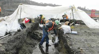 
Archaeologists work in a trench leading to an ancient gravesite Thursday on the 22.5-acre site in Port Angeles, Wash., that the Washington  Department of Transportation had planned to use to build new pontoons and anchors for the aging Hood Canal floating bridge. After the discovery of the remains of hundreds of Indians, state officials have all but decided to abandon the waterfront site. The first remains were discovered in 2003. 
 (Associated Press / The Spokesman-Review)