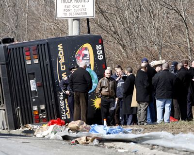 Police Commissioner Raymond Kelly, in leather jacket, speaks with emergency personnel investigating the scene of a bus crash in the Bronx on Saturday. (Associated Press)