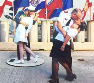 John Chamness, divisional commander of the Salvation Army in Hawaii and the Pacific, enjoys the sunshine in his new post and reprising the iconic World War II V-J Day kiss with wife, Lani, in front of the battleship Missouri. (John Chamness courtesy photo)