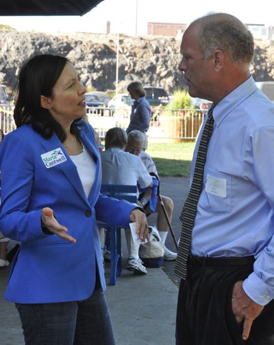 U.S. Sen. Maria Cantwell offers some campaign advice to Daryl Romeyn, a Democrat running for Spokane County commissioner, at the Spokane County Democratic Party's fund-raiser Saturday in Riverfront Park. (Jim Camden)