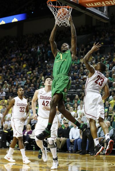 Oregon’s Jordan Bell, center, goes up for the dunk between Washington State’s Conor Clifford, left, and Washington State’s Charles Callison, right, during the first half of an NCAA college basketball game Wednesday, Feb. 24, 2016, in Eugene,. (Ryan Kang / Associated Press)
