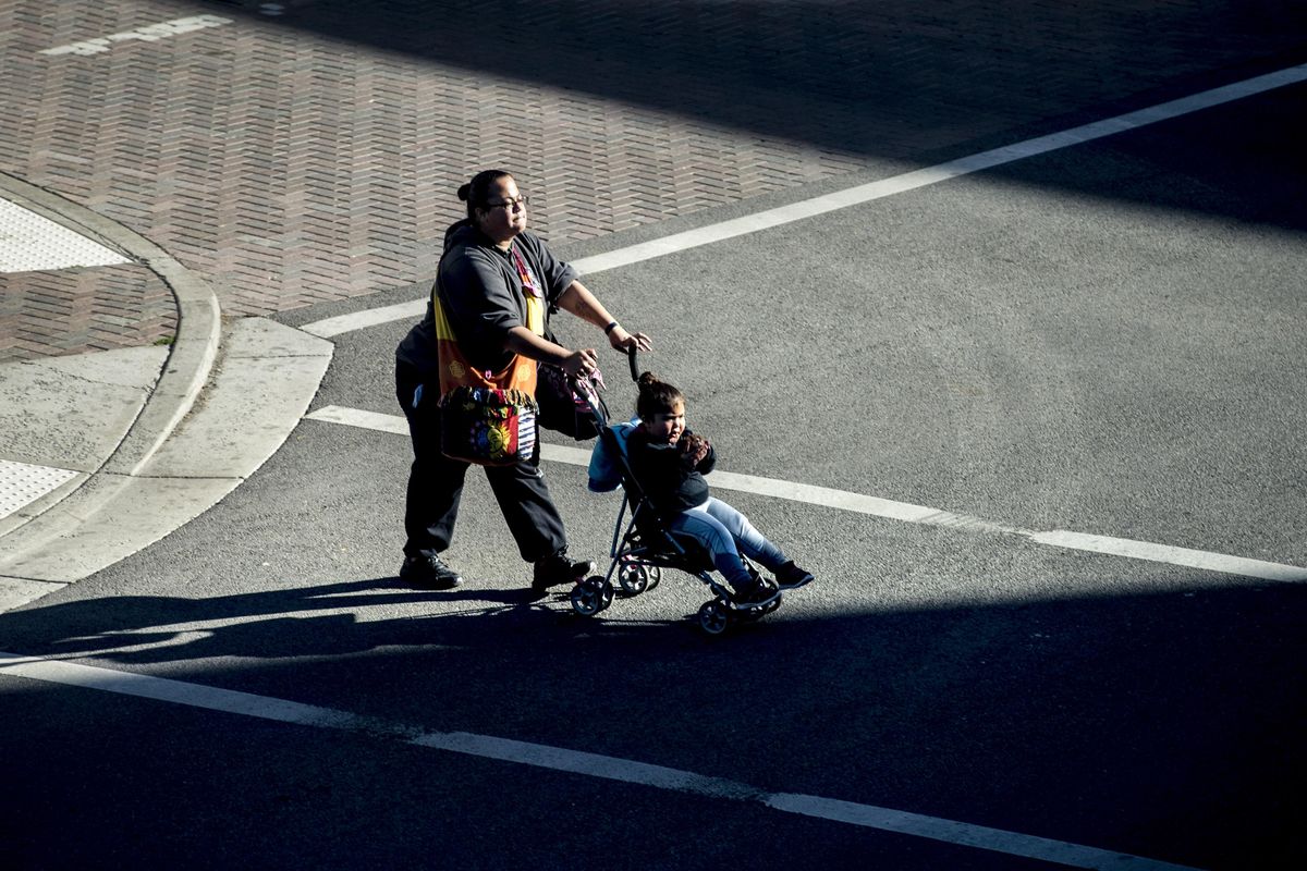 Pedestrians cross Riverside Avenue at Wall Street, Oct. 1, 2017, in downtown Spokane, Wash. (Dan Pelle / The Spokesman-Review)