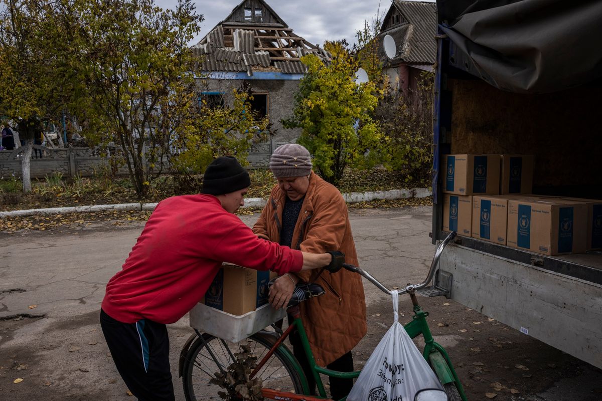 Civilians gather to receive humanitarian aid in the heavily destroyed village of Arkhanhelske, which was liberated from Russian forces earlier this month, in Ukraine on Friday, Oct. 28, 2022. (Ivor Prickett/The New York Times)  (IVOR PRICKETT)