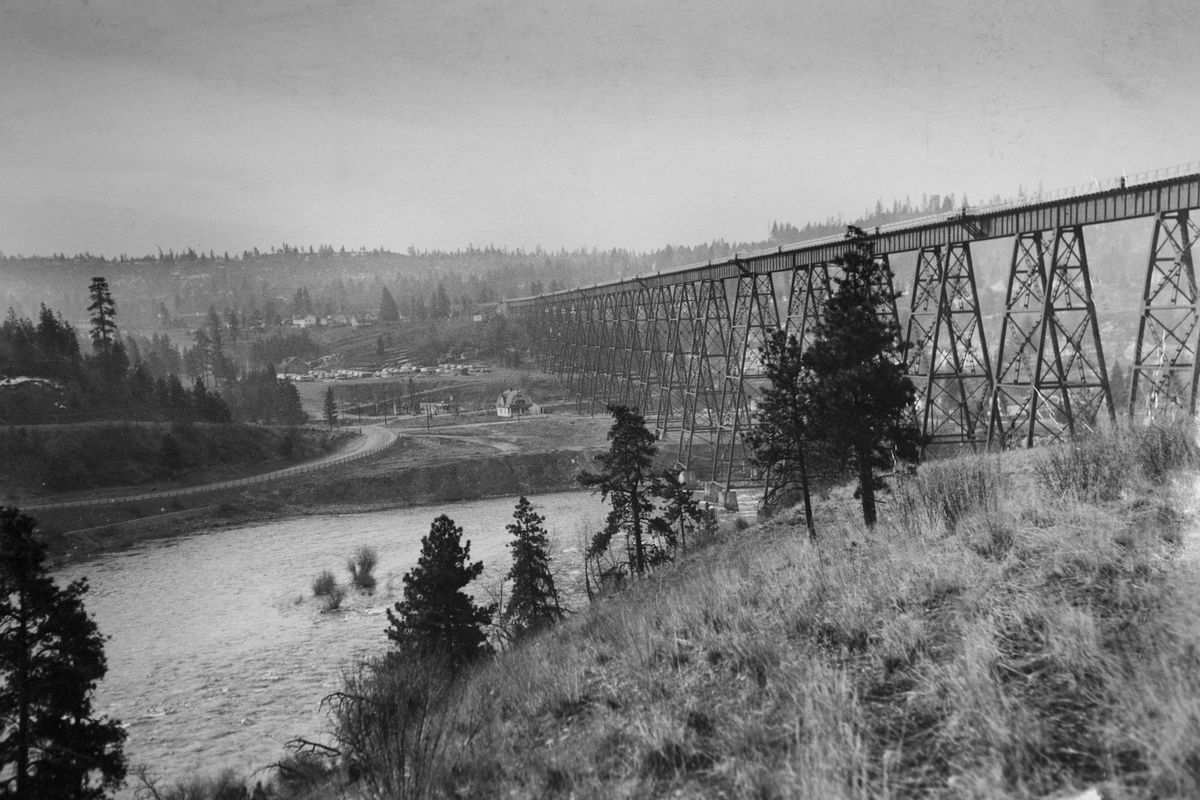 Circa 1940s: The OWR&N railroad bridge was completed around 1914 to move trains to and from the new Union Station in Spokane. This historical photo looks south toward High Bridge Park from across the Spokane River at what is now the Kendall Yards development, though back in the early 20th century, the north rim of the river gorge was mostly railroad tracks and infrastructure. Today’s park is 200 acres.  (COURTESY SPOKANE PARKS AND REC DEPT)