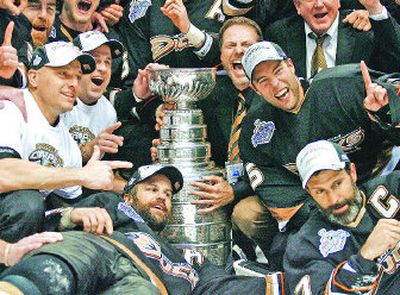 
Anaheim Ducks captain Scott Niedermayer, bottom right, and his brother Rob, bottom left, show off their prize. 
 (Associated Press / The Spokesman-Review)