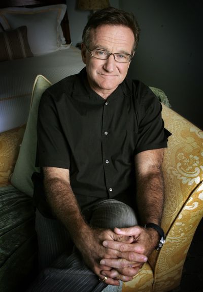 Actor and comedian Robin Williams poses for photos to promote his film 