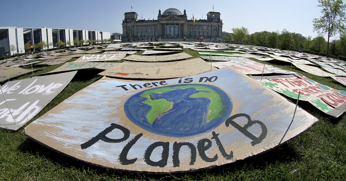 In this Friday, April 24, 2020 file photo, activists place thousands of protest placards in front of the Reichstag building, home of the german federal parliament, Bundestag, during a protest rally of the 