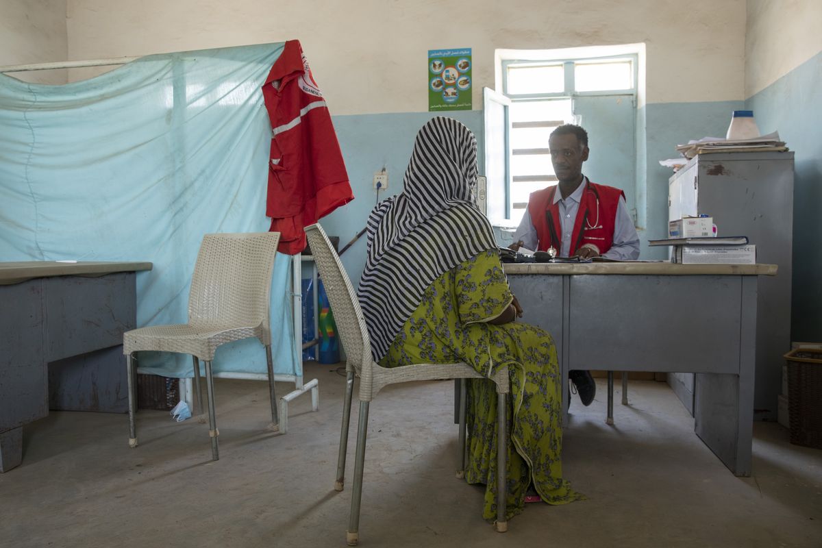 FILE - In this March 23, 2021 file photo, a Tigrayan woman who says she was gang raped by Amhara fighters, speaks to surgeon and doctor-turned-refugee, Dr. Tewodros Tefera, at the Sudanese Red Crescent clinic in Hamdayet near the Sudan-Ethiopia border, in eastern Sudan. A new Amnesty International report published Wednesday, Aug. 11, 2021 says dozens of women have described shocking sexual assaults by Ethiopian soldiers and allied forces in the country's Tigray conflict, and its researcher calls it striking how the perpetrators appeared to act without fear of punishment from their commanders.  (Nariman El-Mofty)