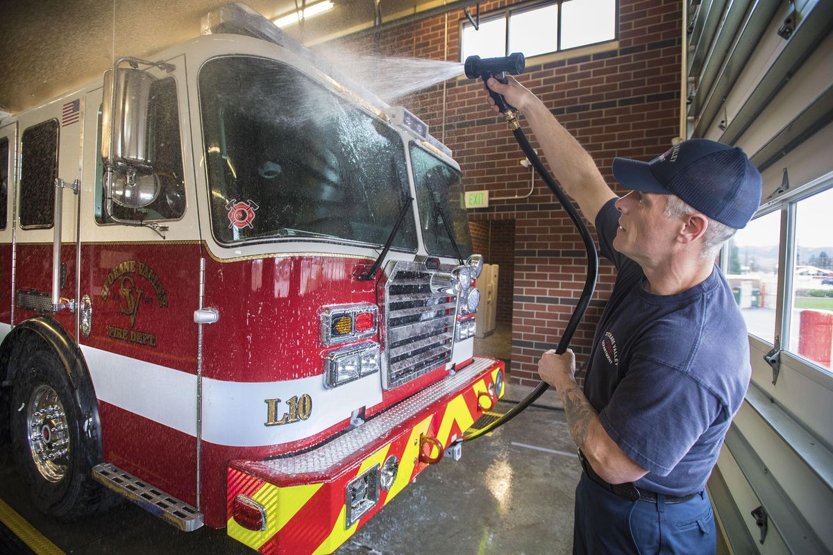 Dave Vegele, of the Spokane Valley Fire Department, washes down their new 101-foot aerial ladder truck in Greenacres Station 10, April 7, 2017, after a training session. The KME truck is 59.11 feet long and can reach up to seven stories high. Dan Pelle/THE SPOKESMAN-REVIEW (Dan Pelle / The Spokesman-Review)