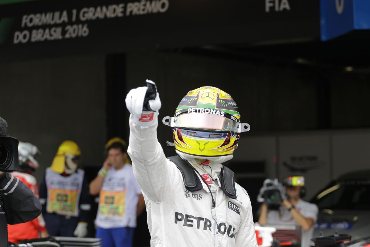 Mercedes driver Lewis Hamilton, of Britain, celebrates after he clocked the fastest time during the qualifying session for the Brazilian Formula One Grand Prix at the Interlagos race track in Sao Paulo, Brazil, Saturday, Nov. 12, 2016. (Nelson Antoine / Associated Press)