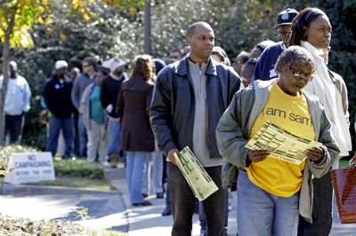 Voters stand in line at an early voting site in Charlotte, N.C., on Thursday. In North Carolina almost 1 million people have voted, and Democrats outnumber Republicans by 2 to 1. (Associated Press / The Spokesman-Review)