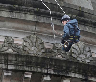 Rope-a-dome: Alec Liebman, of the Golder Associates of Redmond, Wash., rappels down the steep curve of the Legislative Building in Olympia on Wednesday to survey the surface conditions and look for any problem areas. Liebman’s company was hired by the Department of Enterprise Services to document the dome’s condition as part of establishing an ongoing maintenance program. (Associated Press)
