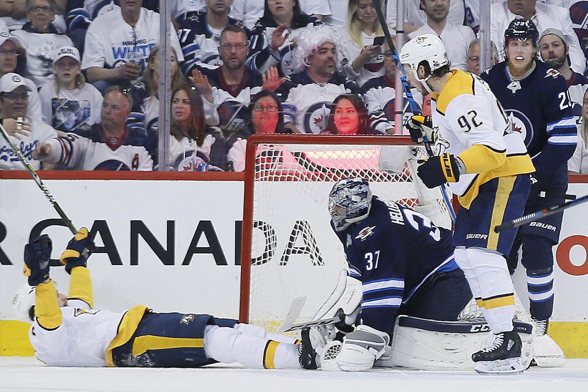 Nashville Predators’ Filip Forsberg (9) and Ryan Johansen (92) celebrate Forsberg’s goal against Winnipeg Jets goaltender Connor Hellebuyck (37) during second period NHL hockey playoff action in Winnipeg, Manitoba, Monday, May 7, 2018. (John Woods / Canadian Press via AP)