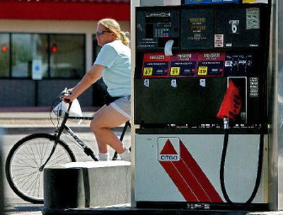 
A cyclist pedals past an out of order gas pump Friday in Tempe, Ariz. The station was out of gas. Sporadic outages throughout metro Phoenix coupled with increasingly high prices has many motorists evaluating their travel habits. 
 (Associated Press / The Spokesman-Review)