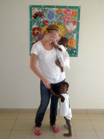This undated photo provided by her family shows Molly Hightower with two unidentified children at Hopital Pediatrique Saint Damien, a free pediatric hospital in Port-au-Prince, Haiti. Hightower, from Port Orchard, Wash., was killed in the collapse of a building at a Port-au-Prince orphanage where she had been a volunteer.  (Associated Press)