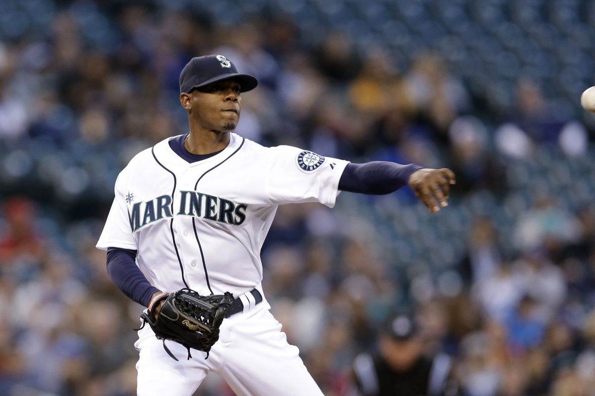 Seattle Mariners starting pitcher Roenis Elias throws to first on a pick-off attempt in the second inning. (Associated Press)