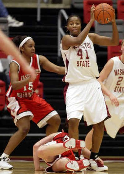 Washington State's Keisha Moore (41) looks for a way around Eastern Washington's Ashley Knight (15) and Felice Moore, on floor.
(Associated Press / The Spokesman-Review)