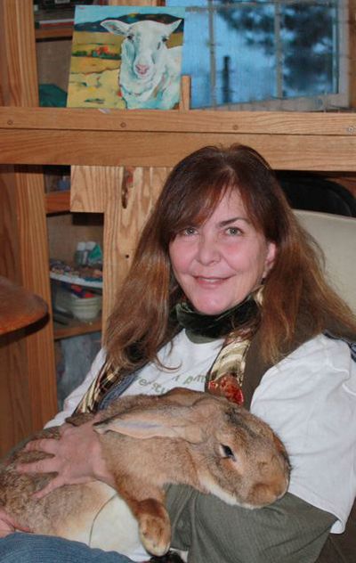 Kit Jagoda poses with a rabbit named Albrecht in her studio in a loft above the bunny barn at her home in the Seven Mile area. 