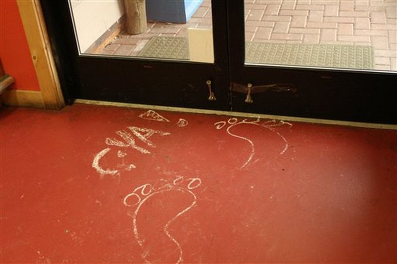 In this Feb. 11, 2010 file photo provided by the Islands' Sounder newspaper, chalk drawings of bare feet are shown on the floor of the Homegrown Market on Orcas Island, Wash., after the store was broken into overnight. The crime was blamed on Colton Harris-Moore, better known as the 