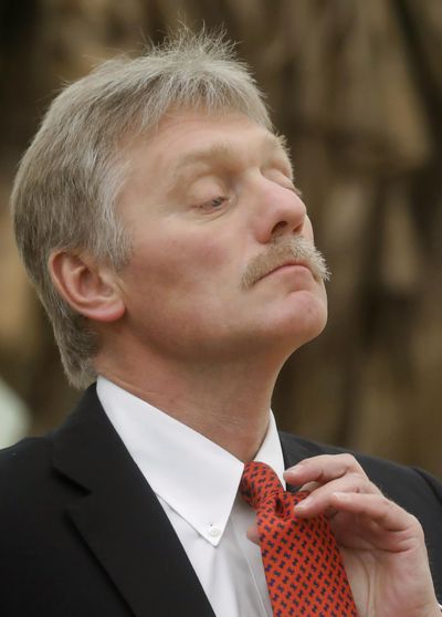 Kremlin spokesman Dmitry Peskov adjusts his tie prior to Russian President Vladimir Putin and Israeli Prime Minister Benjamin Netanyahu's meeting in the Kremlin in Moscow, Russia, Thursday, Jan. 30, 2020. Peskov says he is hospitalized with the coronavirus. (Maxim Shemetov / AP)