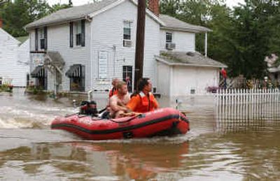 Joe Ellis and his dog, Diva, were rescued Tuesday from their home in Lumberton, N.J., after floodwater started to rise to their second-floor apartment.
(Associated Press / The Spokesman-Review)