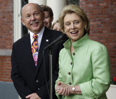 Washington Gov. Chris Gregoire and husband Mike Gregoire stand in front of the Governor’s Mansion Monday after the governor announced she won’t seek a third term. (Associated Press)