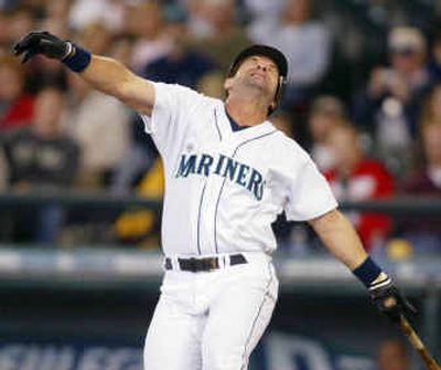 
Seattle designated hitter Edgar Martinez winces after hitting himself with a foul ball in the seventh inning. Martinez didn't bat in the ninth and isn't expected to play today. 
 (Associated Press / The Spokesman-Review)