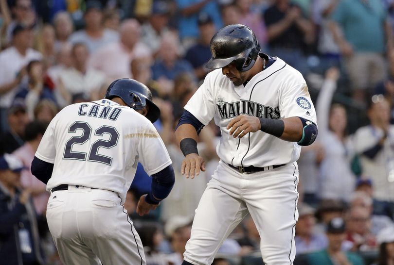 Seattle Mariners' Nelson Cruz, right, celebrates his two-run home run with Robinson Cano, during the fifth inning of a baseball game against the Pittsburgh Pirates on Tuesday in Seattle. (Elaine Thompson / Associated Press)