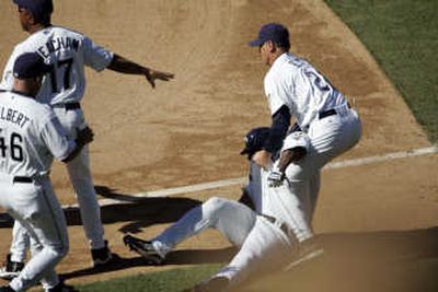 
Milton Bradley is injured as he is restrained by manager Bud Black, right. Associated Press
 (Associated Press / The Spokesman-Review)