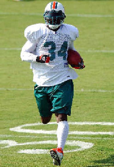 Ricky Williams runs up field after making a catch during the first day of Dolphins camp.
(Associated Press / The Spokesman-Review)