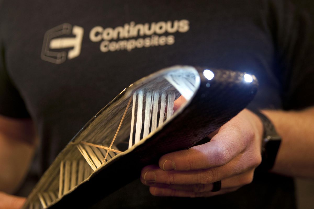 Chris Whalen, marketing director at Coeur d’Alene startup Continuous Composites, holds  a demo piece made with the company’s patented process. (Kathy Plonka / The Spokesman-Review)