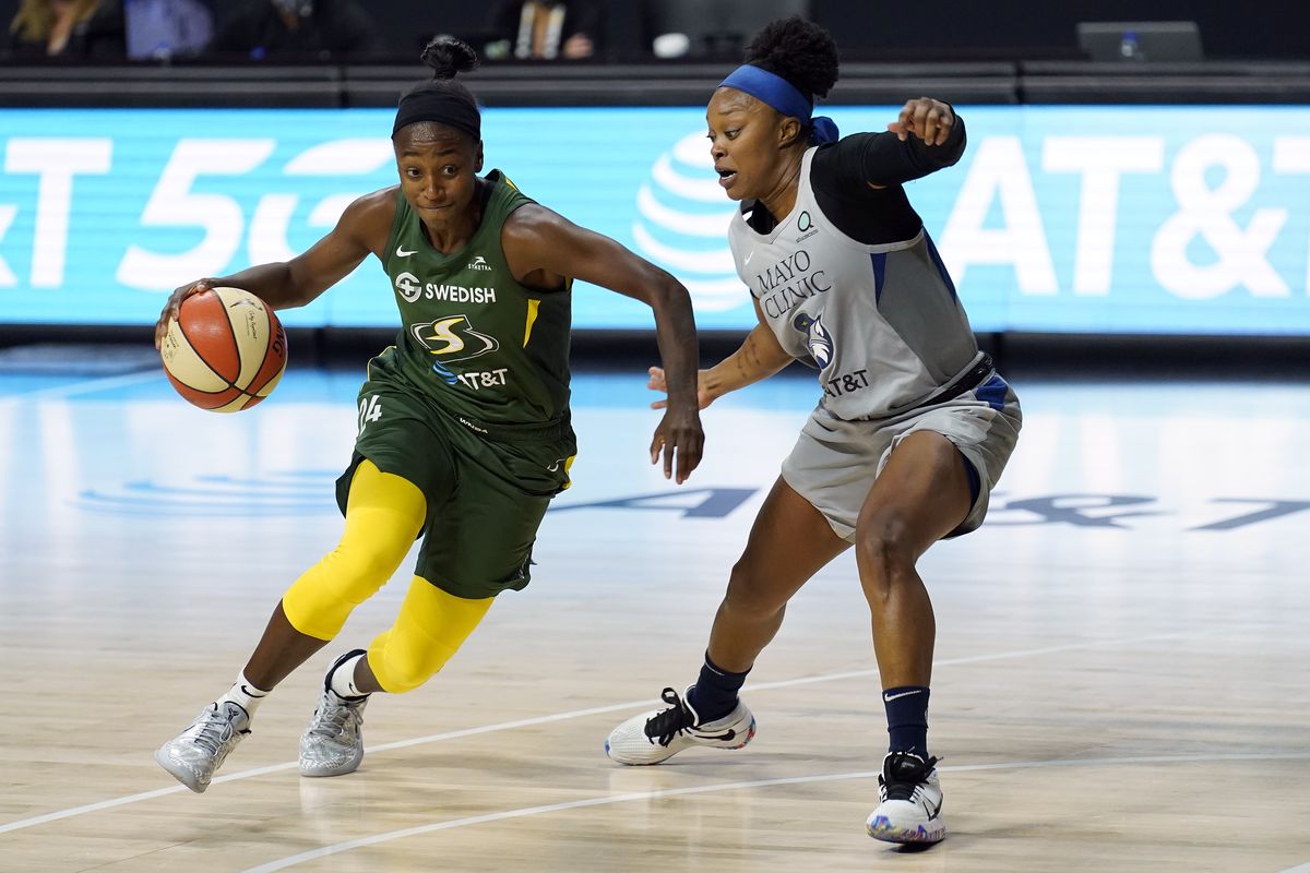 Seattle Storm guard Jewell Loyd (24) drives around Minnesota Lynx guard Odyssey Sims (1) during the second half of Game 2 of a WNBA basketball semifinal round playoff series Thursday, Sept. 24, 2020, in Bradenton, Fla.  (Associated Press)